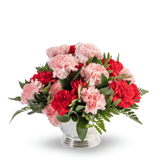 Red and pink carnations arranged in a silver bowl, perfect for Christmas décor or gifting.